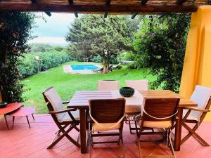 a patio with a table and chairs and a pool at Villa Sole con piscina privata in Cuile Pazzoni