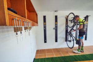 a man is holding a bike in a room with bats at Sa Tanca in Pòrtol