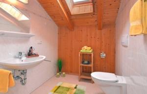 a bathroom with a white toilet and a sink at Fillerhof in Villnoss