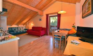 a kitchen and living room with a red couch at Fillerhof in Villnoss