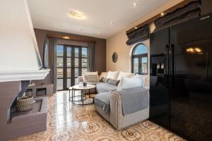 a living room with a couch and a fireplace at Afentika Grand Flat in Archangelos