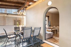 a room with a table and chairs and a bedroom at Afentika Grand Flat in Archangelos