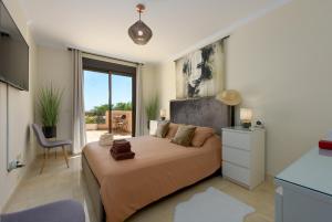 a bedroom with a large bed with a large window at Casares Beach luxe penthouse in Casares