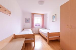 a bedroom with two beds and a window at Appartment Isabelle in Lake Pressegg