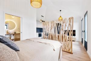 a bedroom with a bed and a dining room at Ocean View Villas in Caniço
