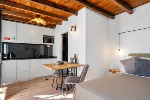 a bedroom with a bed and a table and a kitchen at Ocean View Villas in Caniço