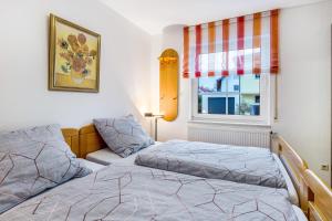 a bedroom with two beds and a window at Residenz Malscher Aue in Malsch