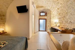 a bedroom with a bed and a sink in a room at Eclissi suite in Giovinazzo +16 photos