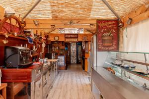 an inside view of a restaurant kitchen with a counter at Oasis on the river in Marina di Pisa +22 photos