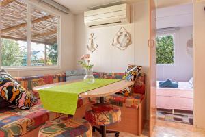 a dining room with a table and a couch at Oasis on the river in Marina di Pisa