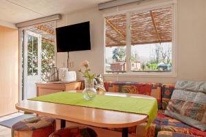 a living room with a table and a couch at Oasis on the river in Marina di Pisa