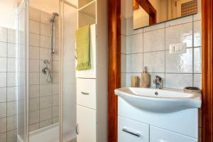 a bathroom with a sink and a shower at The Domus vicino ad Alghero in Olmedo +15 photos