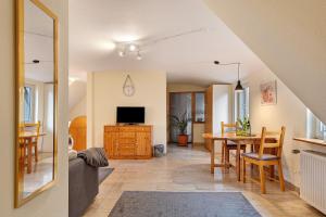 a living room with a table and a dining room at Ferienwohnung F Bolanz 1 in Auggen