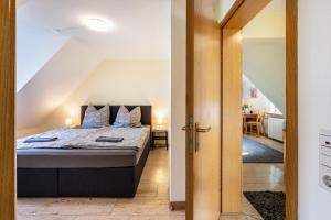 a bedroom with a bed and a dining room at Ferienwohnung F Bolanz 1 in Auggen
