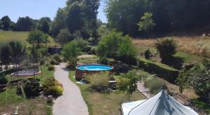 an aerial view of a garden with a swimming pool at Location Fermette in Goulles