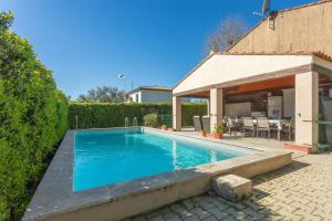 a swimming pool in a yard next to a house at Chambre d'hôtes in Lorgues