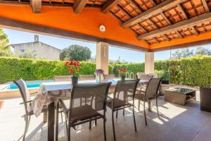 a patio with a table and chairs and a pool at Chambre d'hôtes in Lorgues