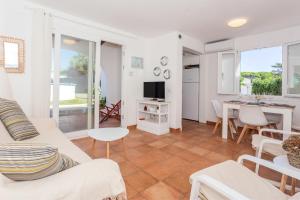 a living room with a couch and a table at Sa Sivina in Cala en Bosc
