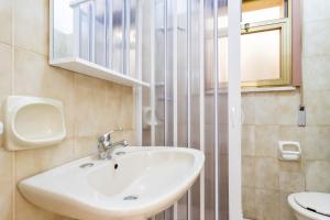 a bathroom with a sink and a toilet at Villetta Lido Canne in Torre Lapillo +17 photos