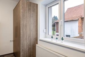 a room with a window and a wooden door at Haus Fuldablick in Rotenburg an der Fulda