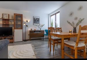 a living room with a table and a dining room at Haus Laffina in Büsum