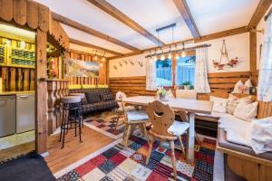 a kitchen and living room with a table and chairs at Hochfügenblick-ski- und Wanderhütte in Hochfugen