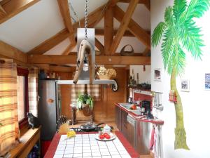 a kitchen with wooden walls and a ceiling at Chambre D'hôtes Du Mas in Saint-Vitte-sur-Briance