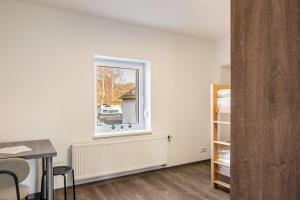 a room with a window and a table and a bedroom at Haus Fuldablick in Rotenburg an der Fulda