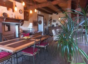 a dining room with a table and a potted plant at Chambre D'hôtes Du Mas in Saint-Vitte-sur-Briance +9 photos