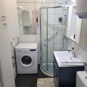 a bathroom with a washing machine and a sink at Mirador los molinos in San Bartolomé +12 photos