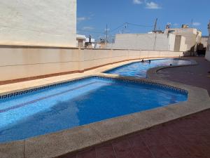 a swimming pool on the side of a building at Calpe Bay in Calpe