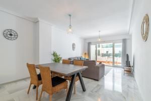 a living room with a table and chairs and a couch at Calpe Bay in Calpe