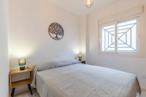 a white bedroom with a bed and a window at Calpe Bay in Calpe +19 photos