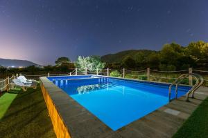 a large blue swimming pool at night at Rustic Escape by Fidalsa in Ibi