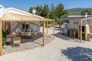 a patio with a table and a house at Rustic Escape by Fidalsa in Ibi