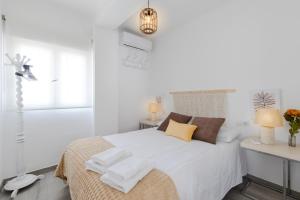 a white bedroom with a bed with towels on it at Rustic Escape by Fidalsa in Ibi