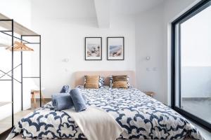 a bedroom with a large bed with blue and white sheets at Ptm riverview T2 luxe 2nd floor in Portimão