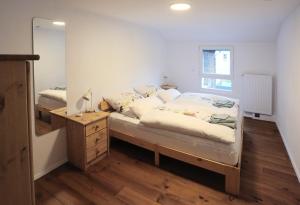 a bedroom with a bed and a dresser and a mirror at Quartierblancdenoir Wohnungen in Reil