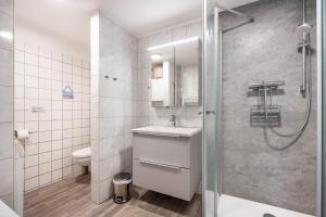 a bathroom with a sink and a shower at Ferienwohnung Schmolei in Kronprinzenkoog +41 photos