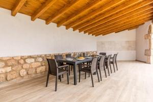 a dining room with a black table and chairs at Fidalsa Rest Station in Burgos