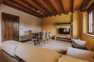a living room with a couch and a table and a television at Fidalsa Rest Station in Burgos