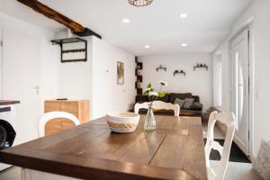 a kitchen and living room with a wooden table and chairs at Lilly in Meßkirch