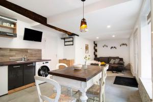 a kitchen and living room with a wooden table and chairs at Lilly in Meßkirch