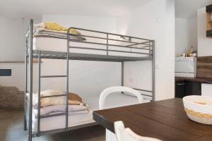 a metal bunk bed in a kitchen with a table at Lilly in Meßkirch