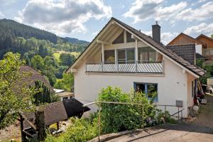a house with a balcony on top of it at Am Sommerrain in Elzach
