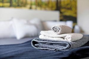 a stack of towels sitting on top of a bed at Am Sommerrain in Elzach +30 photos