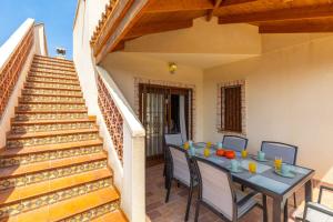 a patio with a table and chairs and stairs at Mountain Beautiful by Fidalsa in Busot