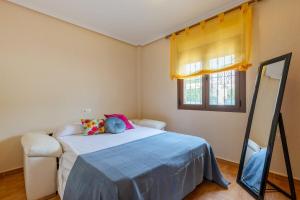 a bedroom with a bed and a window and a mirror at Mountain Beautiful by Fidalsa in Busot +24 photos