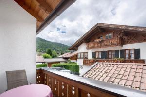 a balcony with a view of a house at Ferienhaus Werdenfels in Mittenwald