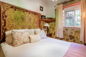 a bedroom with a bed with a large tapestry at La Cuina De Paqui in Caserío Calandari +18 photos